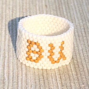 Gold "BU" on Cream
